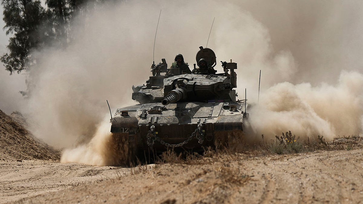 Israeli tank kicks up dust on road