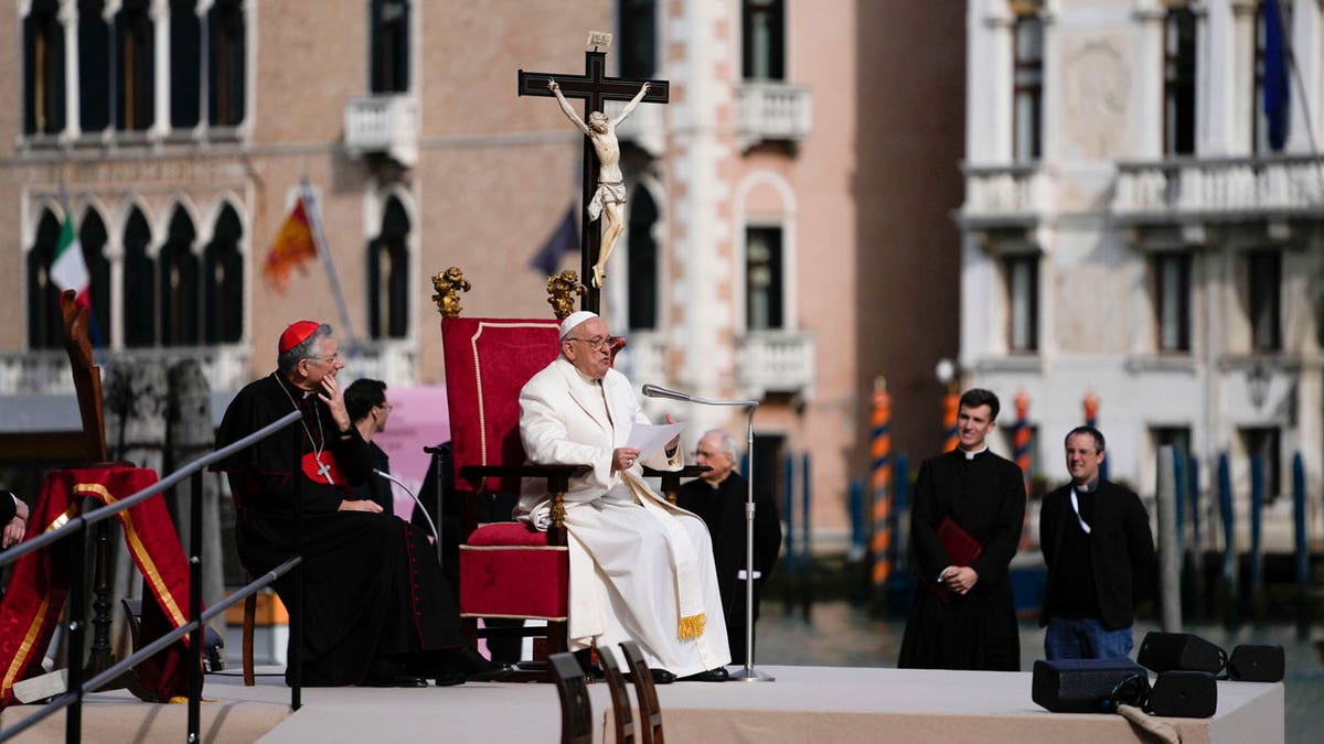 Pope Francis delivers his message as he meets with young people in front of the Church of the Salute in Venice