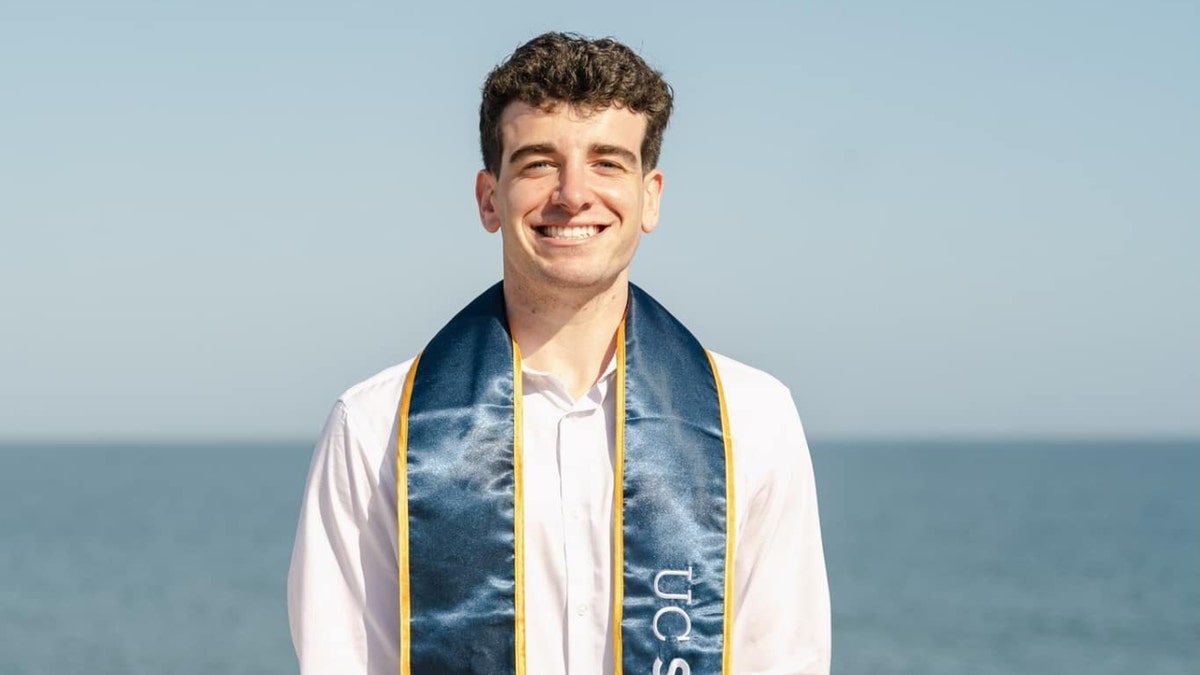 Jake Parker wearing a graduation sash