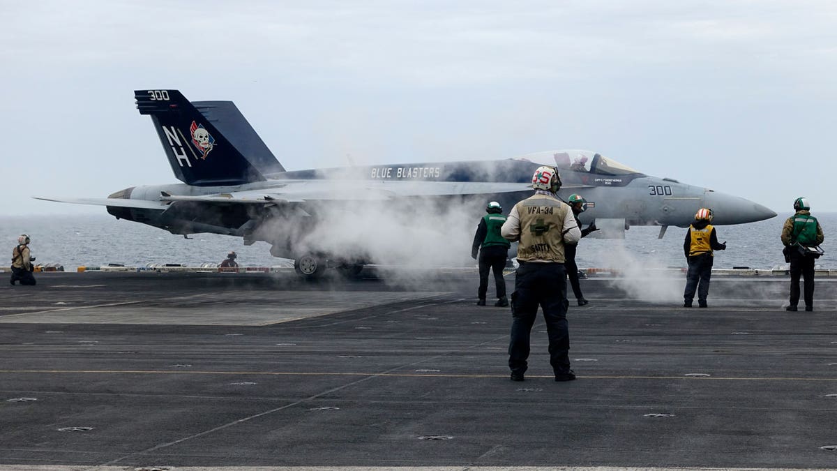A F-18E combatant pitchy prepares to return disconnected from USS Theodore Roosevelt craft carrier