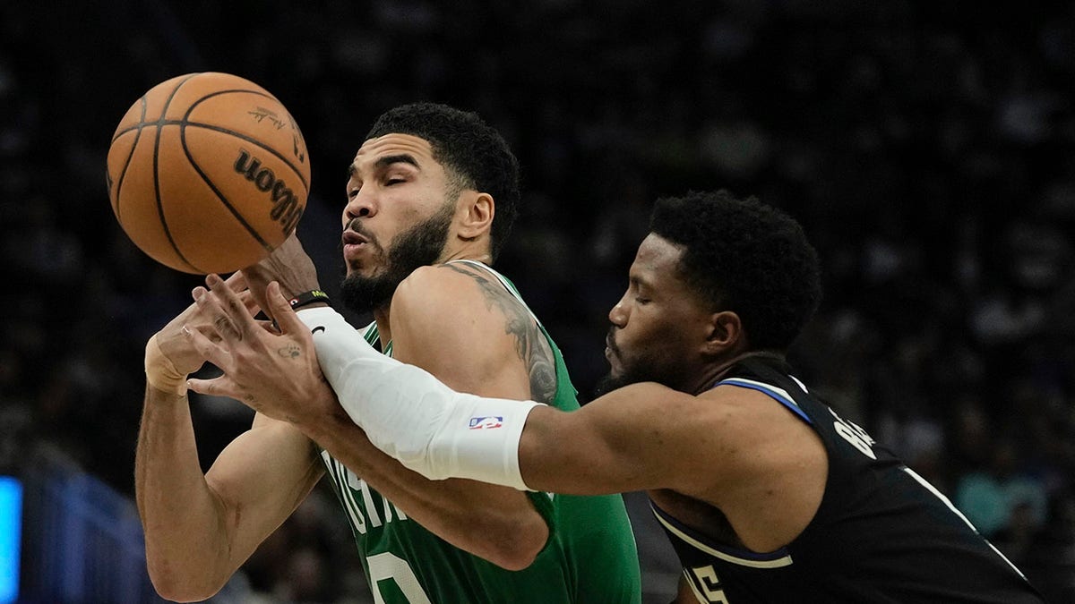 Jayson Tatum drives on Malik Beasley