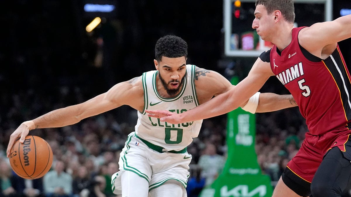 Jayson Tatum drives on Nikola Jovic