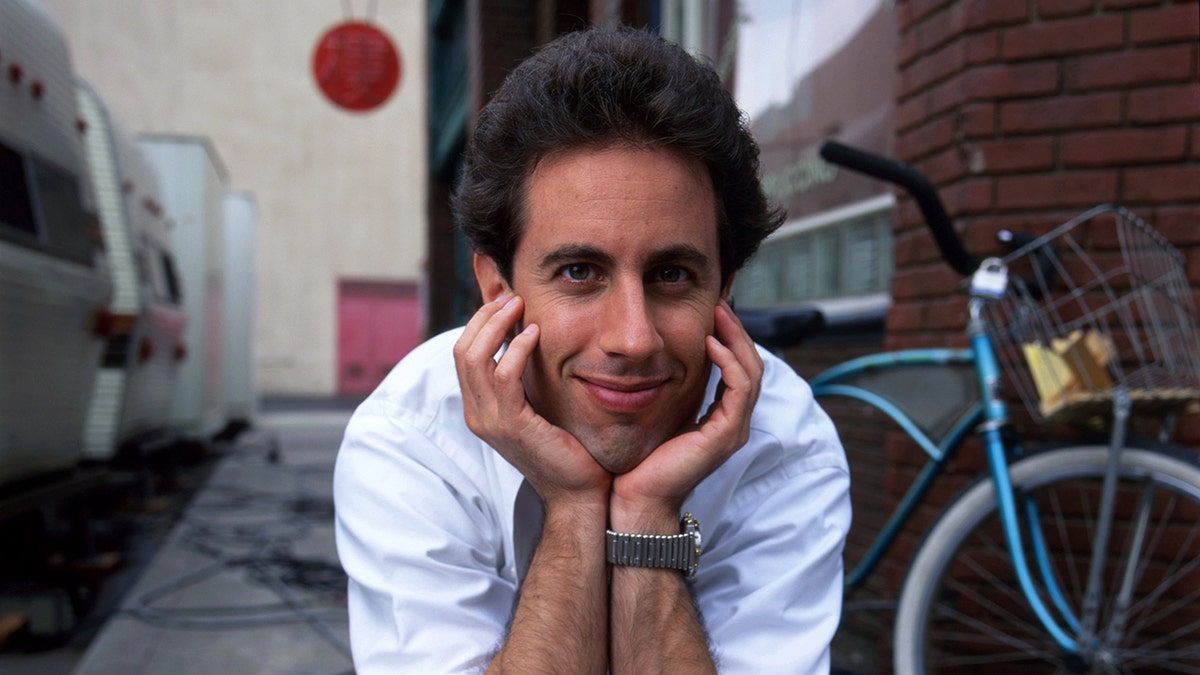 Jerry Seinfeld sits with his head in his heads
