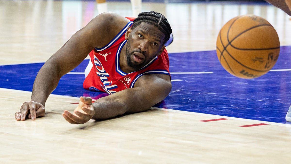 Joel Embiid dives for the loose ball