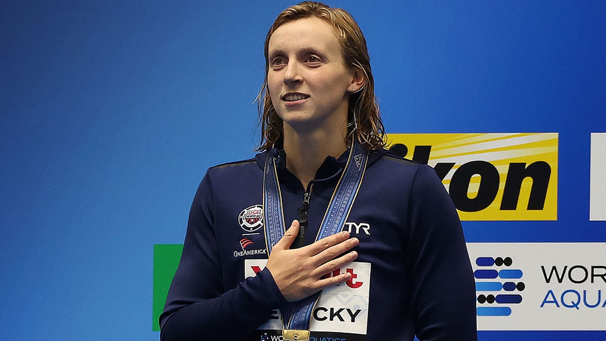 Katie Ledecky with her hand over her heart
