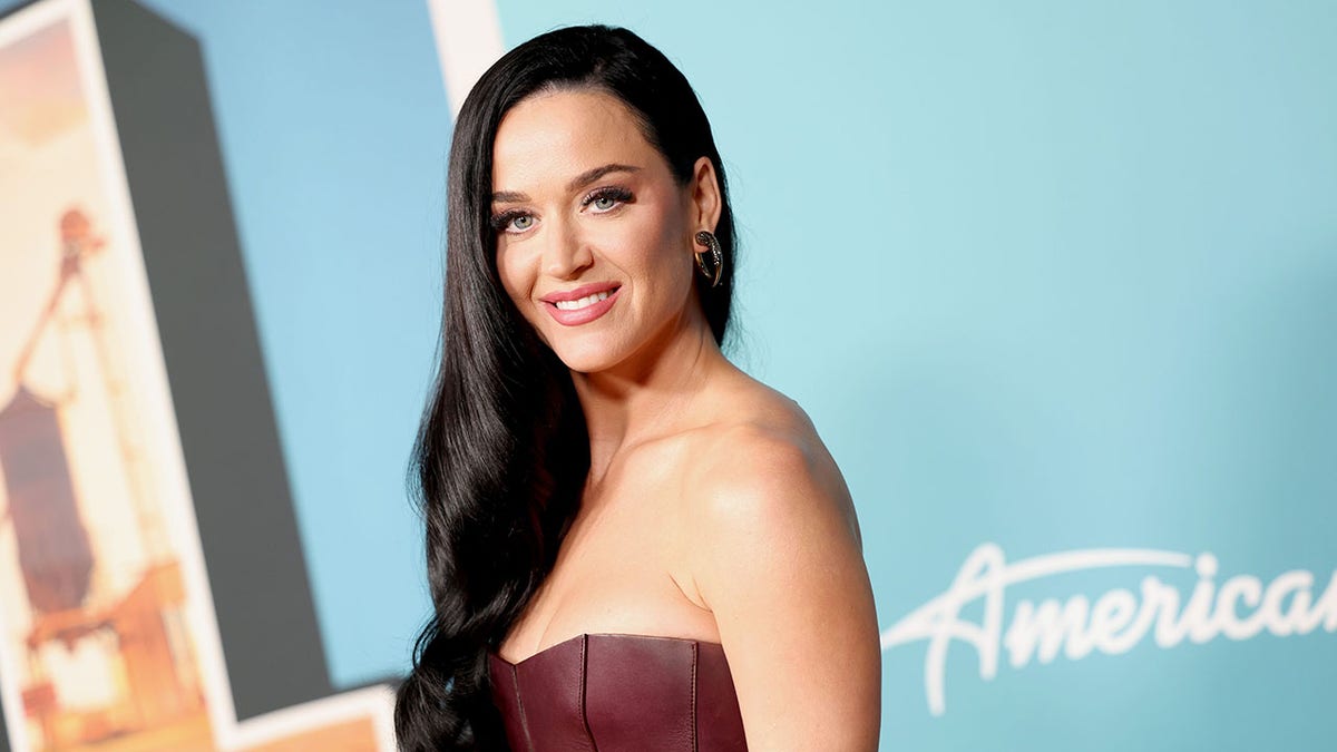 Katy Perry smiling connected reddish carpet