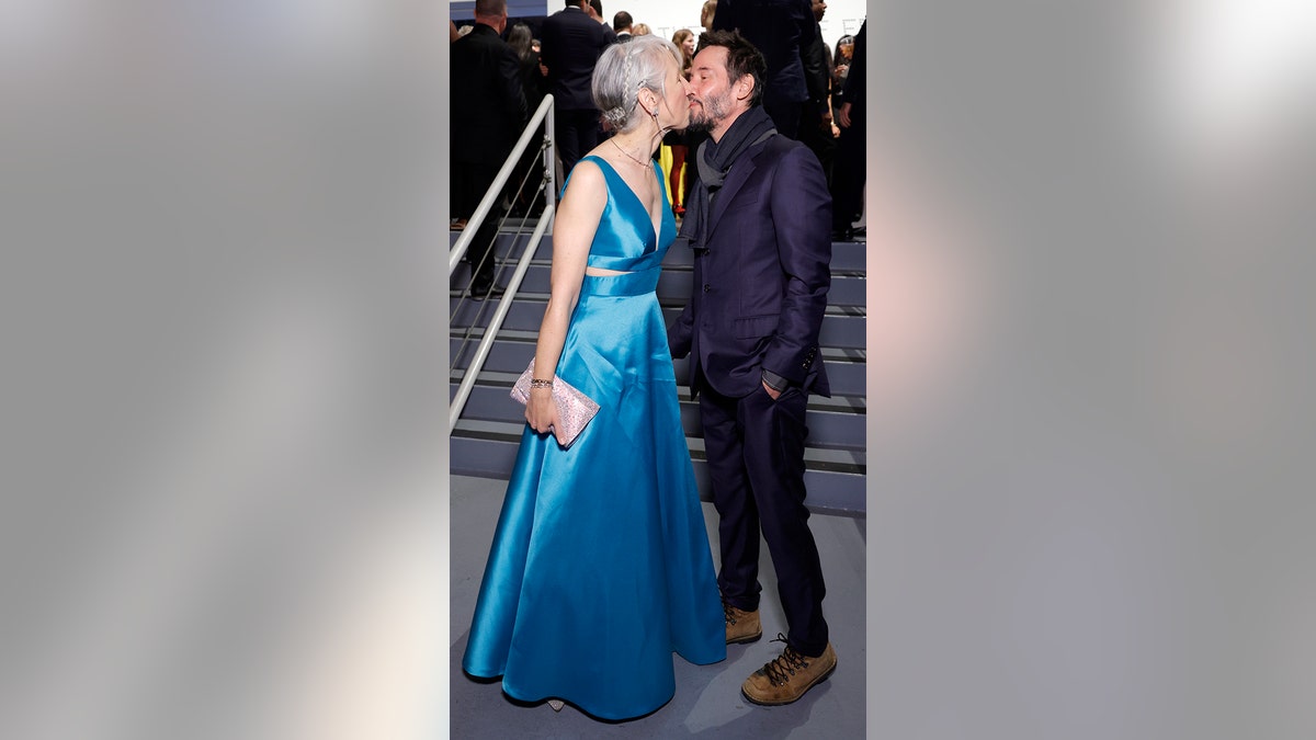 Keanu Reeves kisses his girlfriend, Alexandra Grant on the mouth at a gala