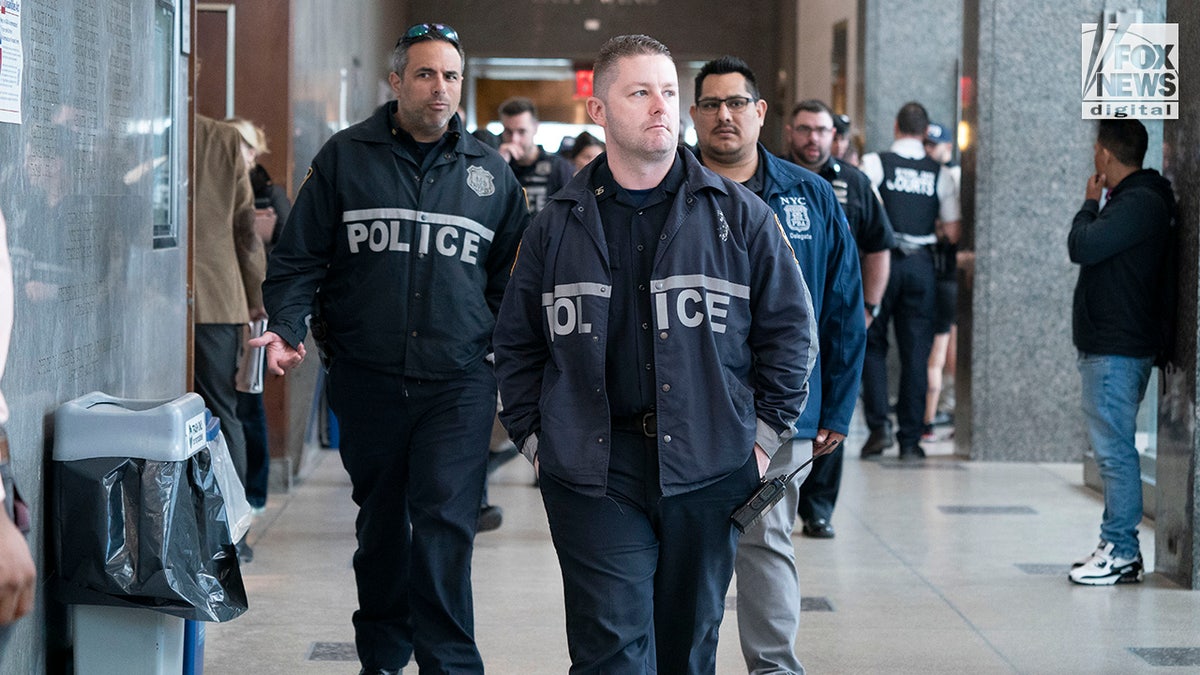 NYPD officers arrive at the Queens Supreme Court as Lindy Jones is arraigned in New York