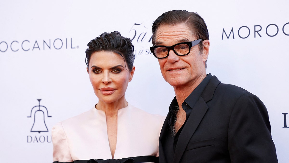 Lisa Rinna and Harry Hamlin posing together on the red carpet