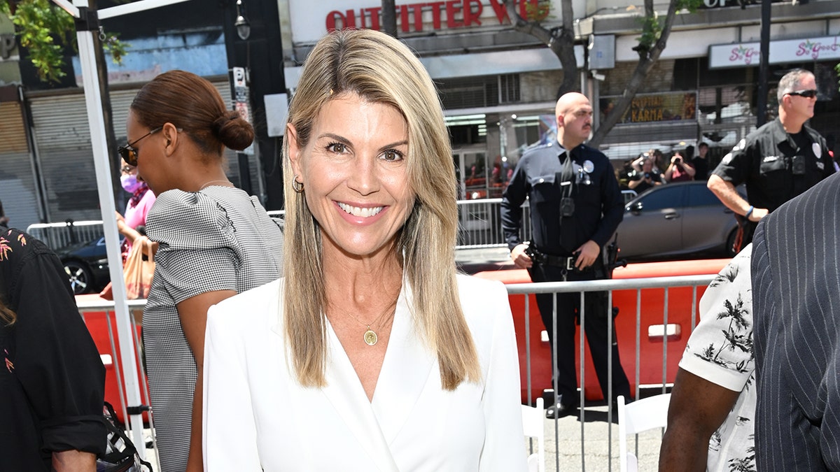 Lori Loughlin smiling connected a nationalist street