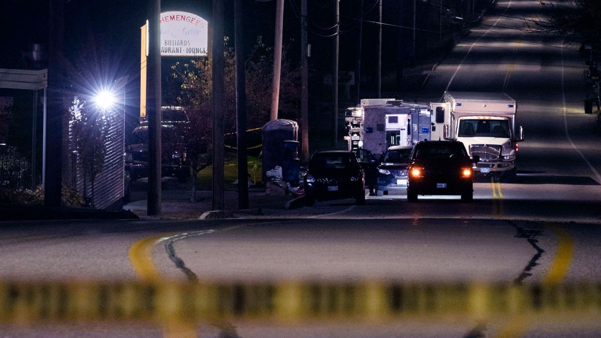 Police tape cordons off the road to Schemengees Bar and Grille in the aftermath of a mass shooting by Army reservist Robert Card in Lewiston, Maine