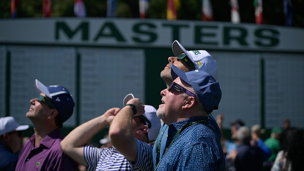 Golf fans look at solar eclipse at 2024 Masters