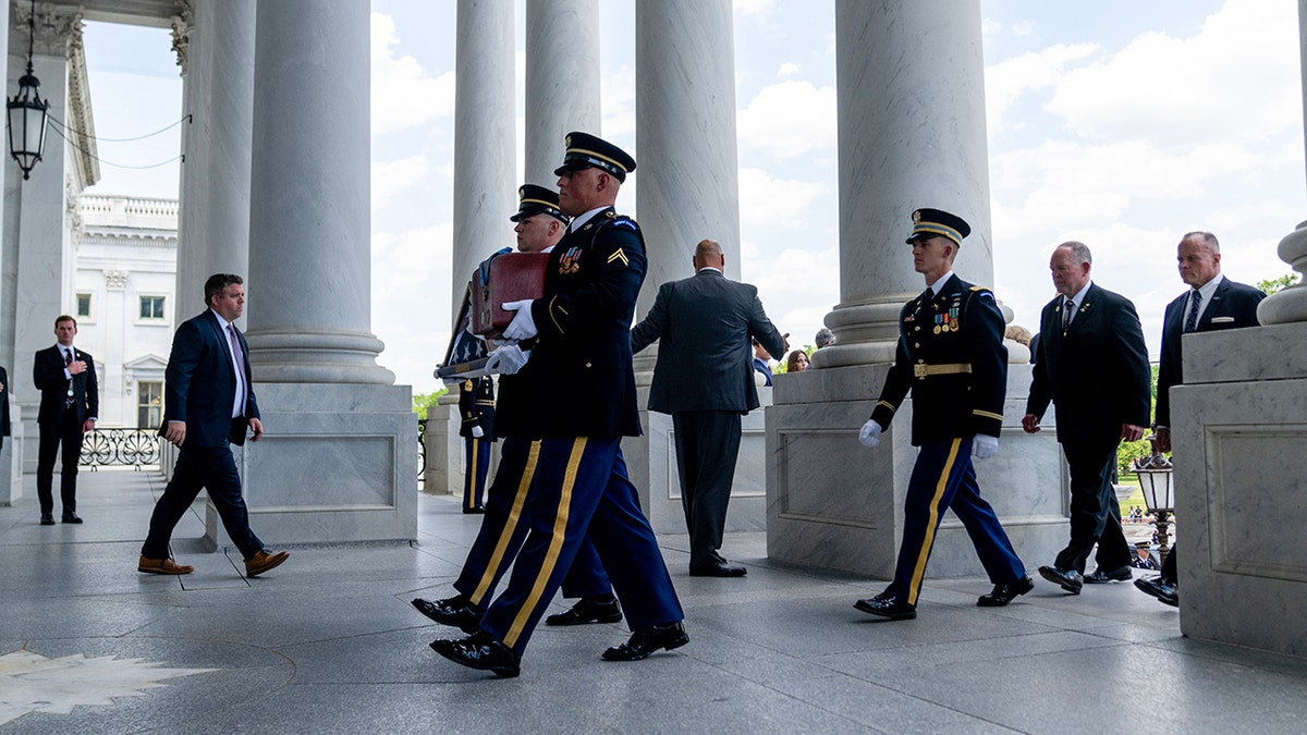 Urn of the precocious   U.S. Army Col. Ralph Puckett arrives astatine  US Capitol
