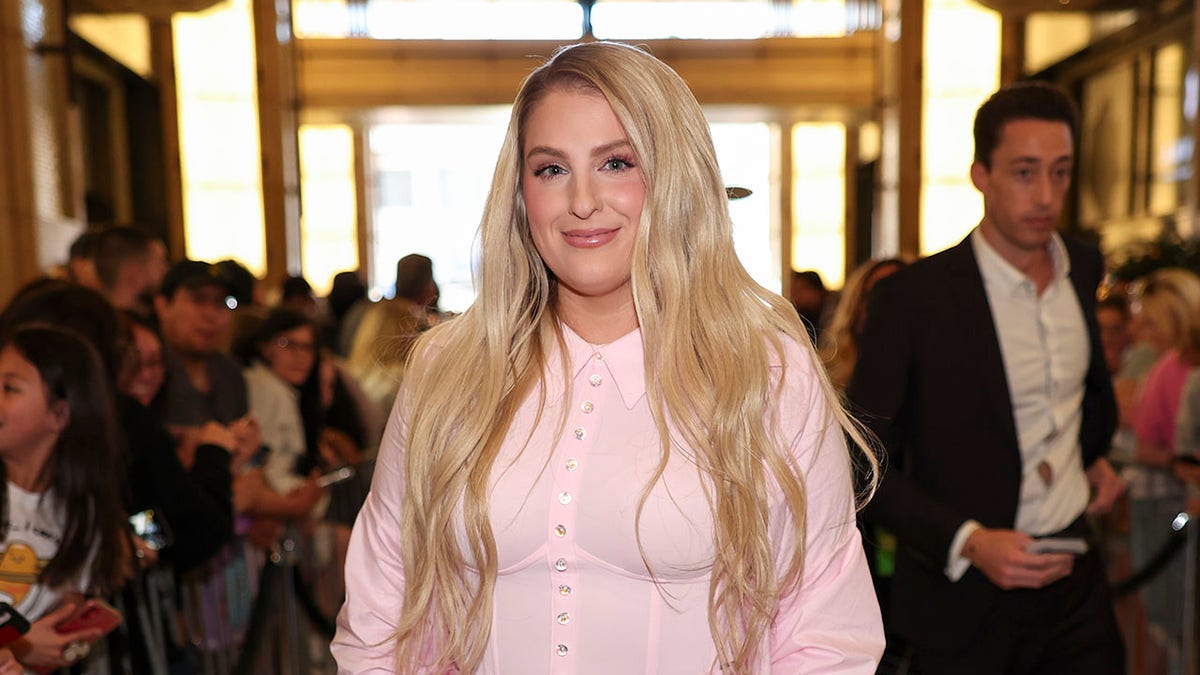 Meghan Trainor smiling in a pink outfit