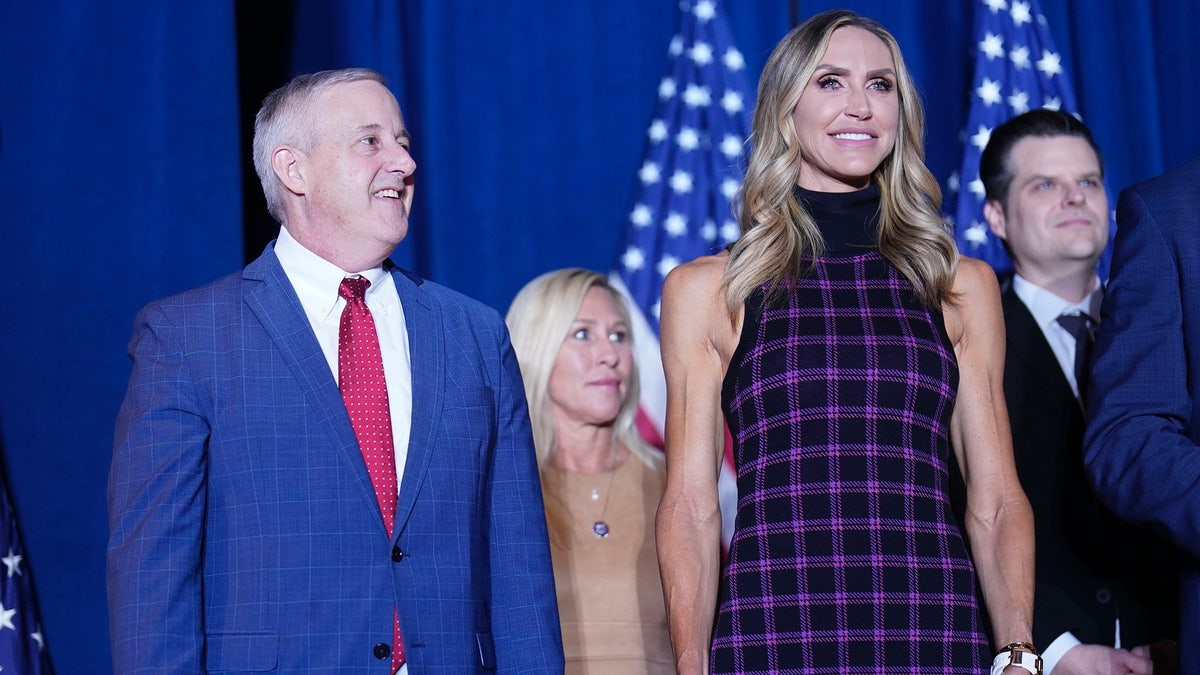 Lara Trump, right, with Michael Whatley, left at rally