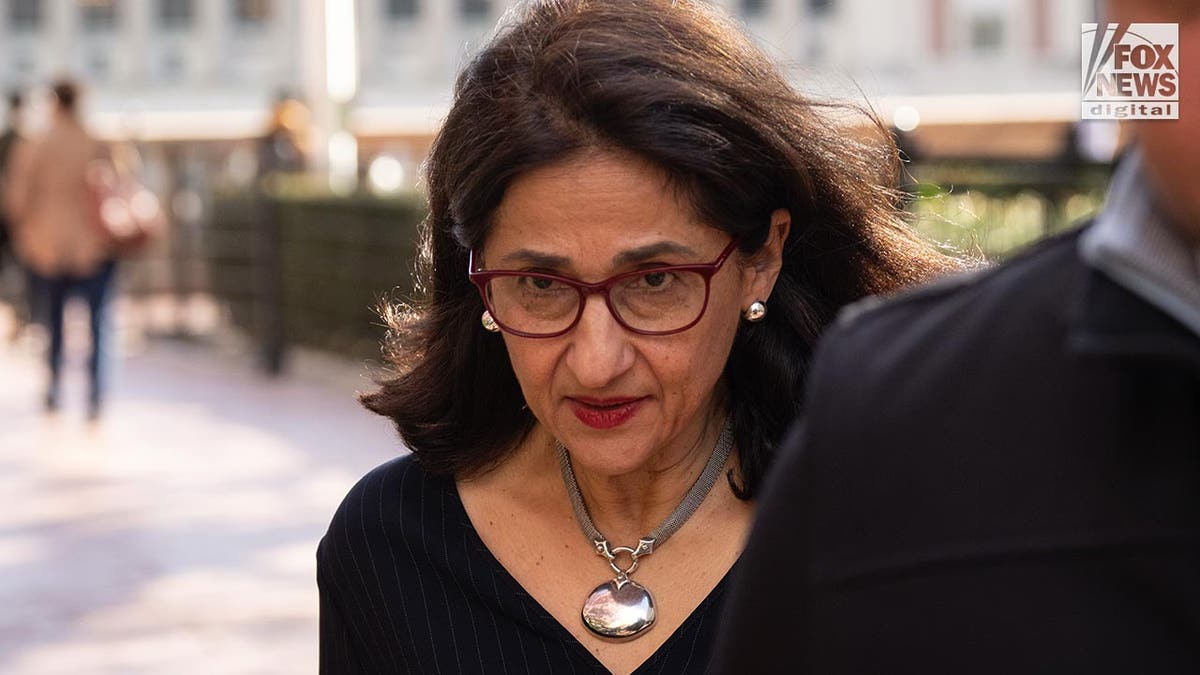 Nemat Shafik looks consecutive  up  arsenic  she walks connected  campus