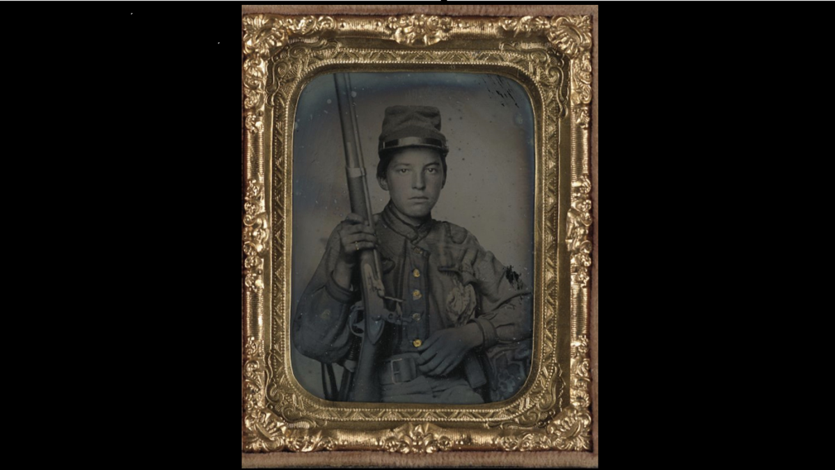 Sergeant William T. Biedler, 16 years old, of Company C, Mosby's Virginia Cavalry Regiment with flintlock musket.