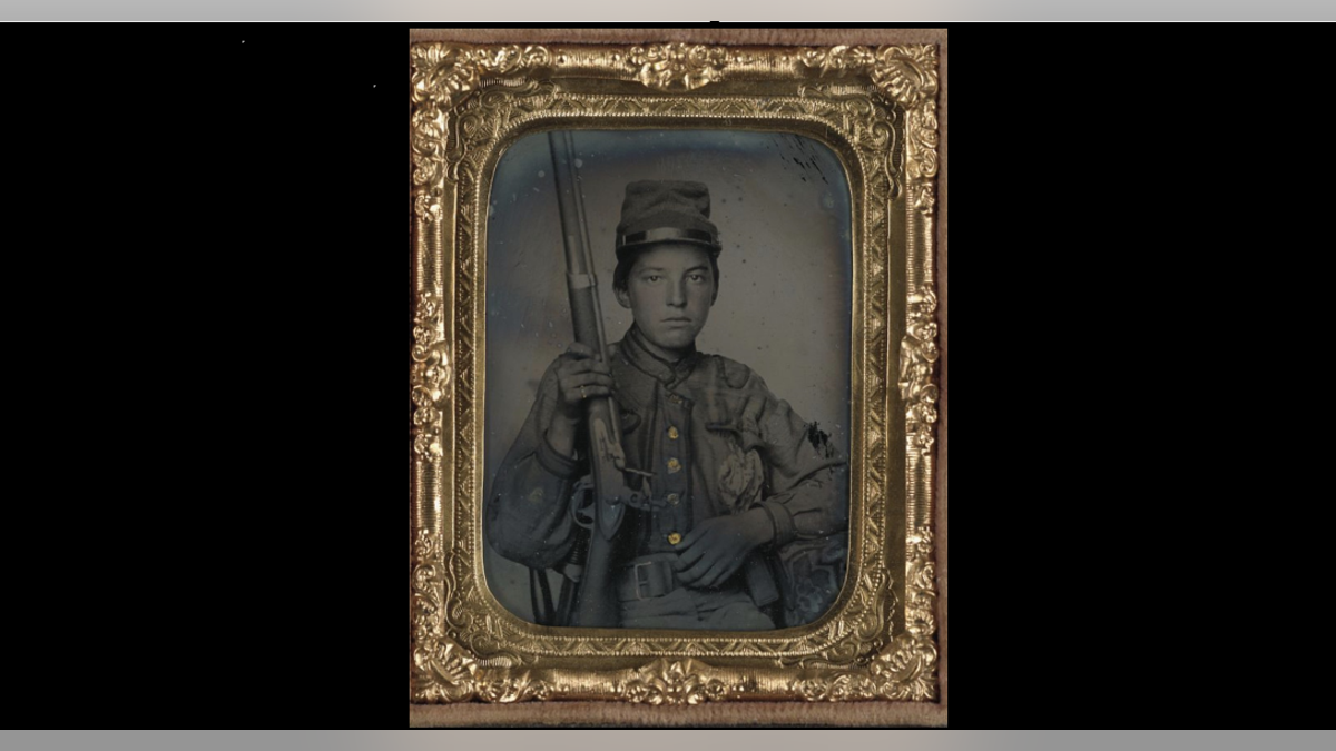 Sergeant William T. Biedler, 16 years old, of Company C, Mosby's Virginia Cavalry Regiment with flintlock musket.