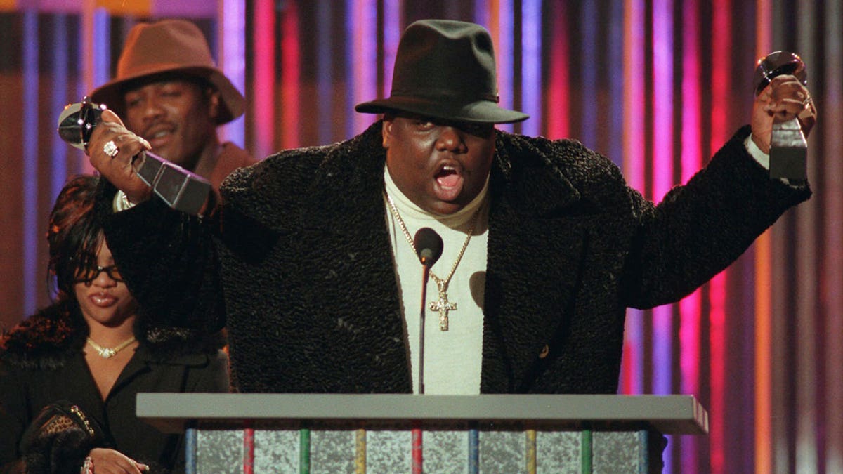 Notorious B.I.G., holds his awards at the podium during the Billboard Music Awards in New York on Dec. 6, 1995.
