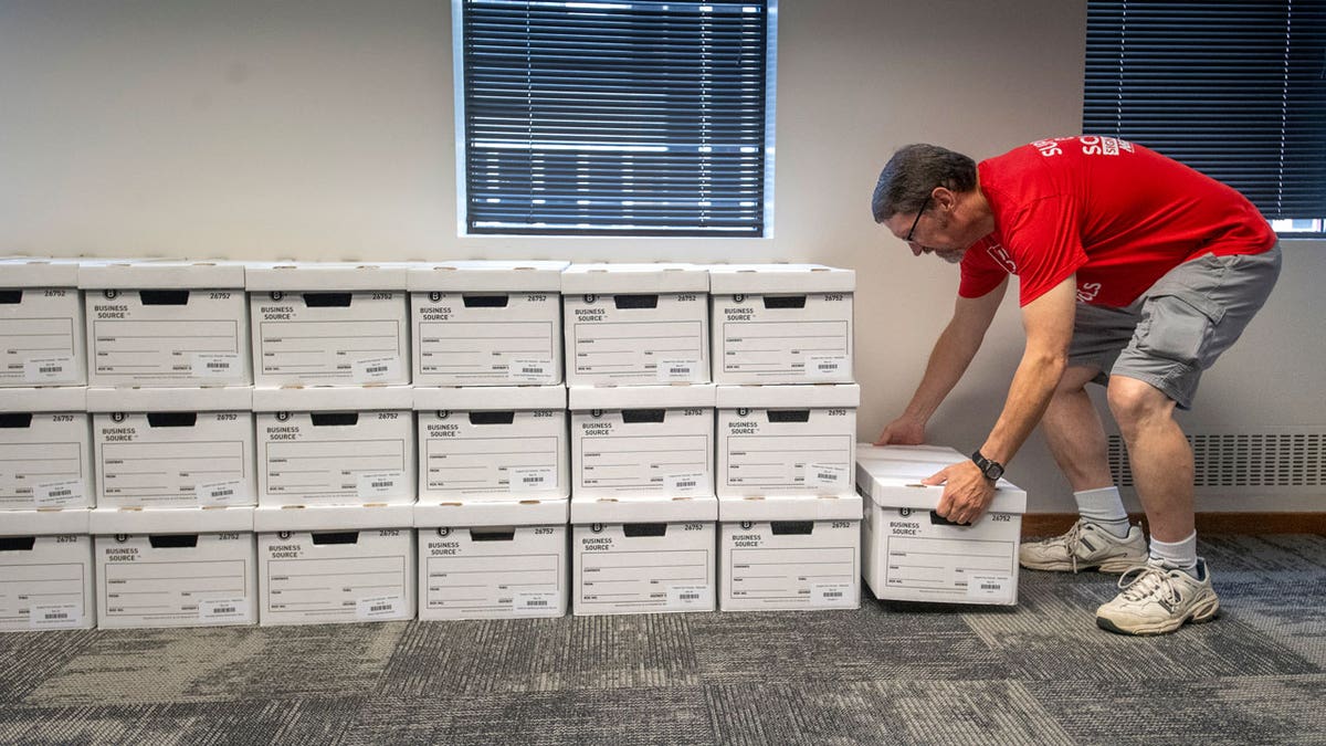 John Heineman delivers a box of petition signatures from Support Our Schools Nebraska to the Nebraska Secretary of State