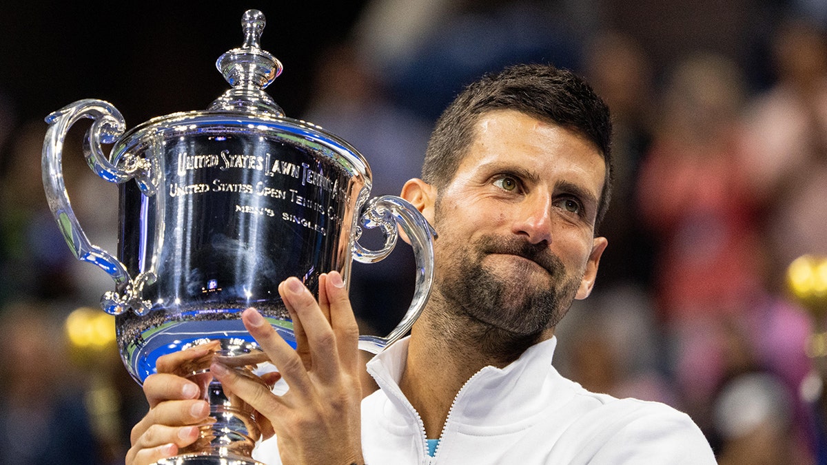 Novak Djokovic raises a trophy