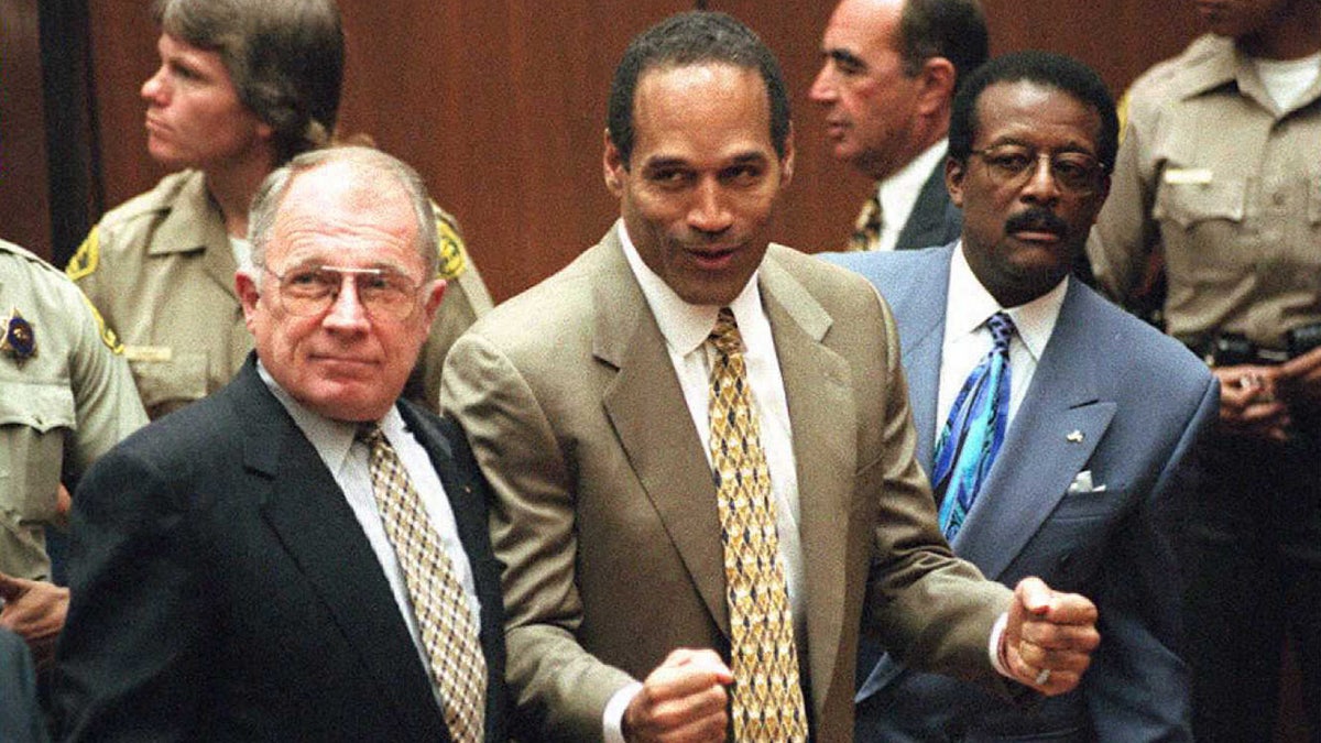 Murder defendant O.J. Simpson listens to the not guilty verdict with his attorneys F. Lee Bailey and Johnnie Cochran Jr