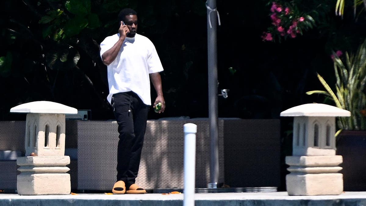P Diddy is on his waterfront spot at his home in Miami walking while on the phone