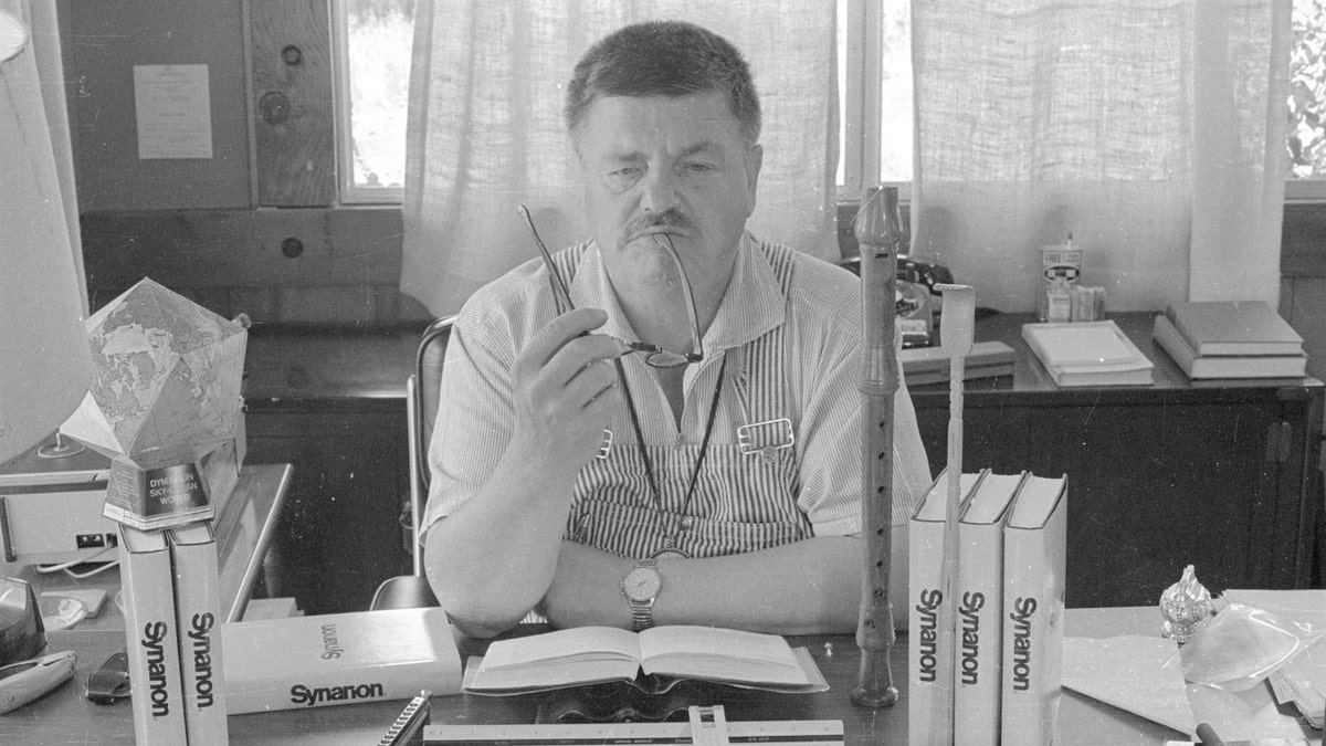 Charles Diederich surrounded by his books