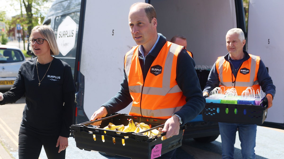 Prince William carrying a crate of bananas