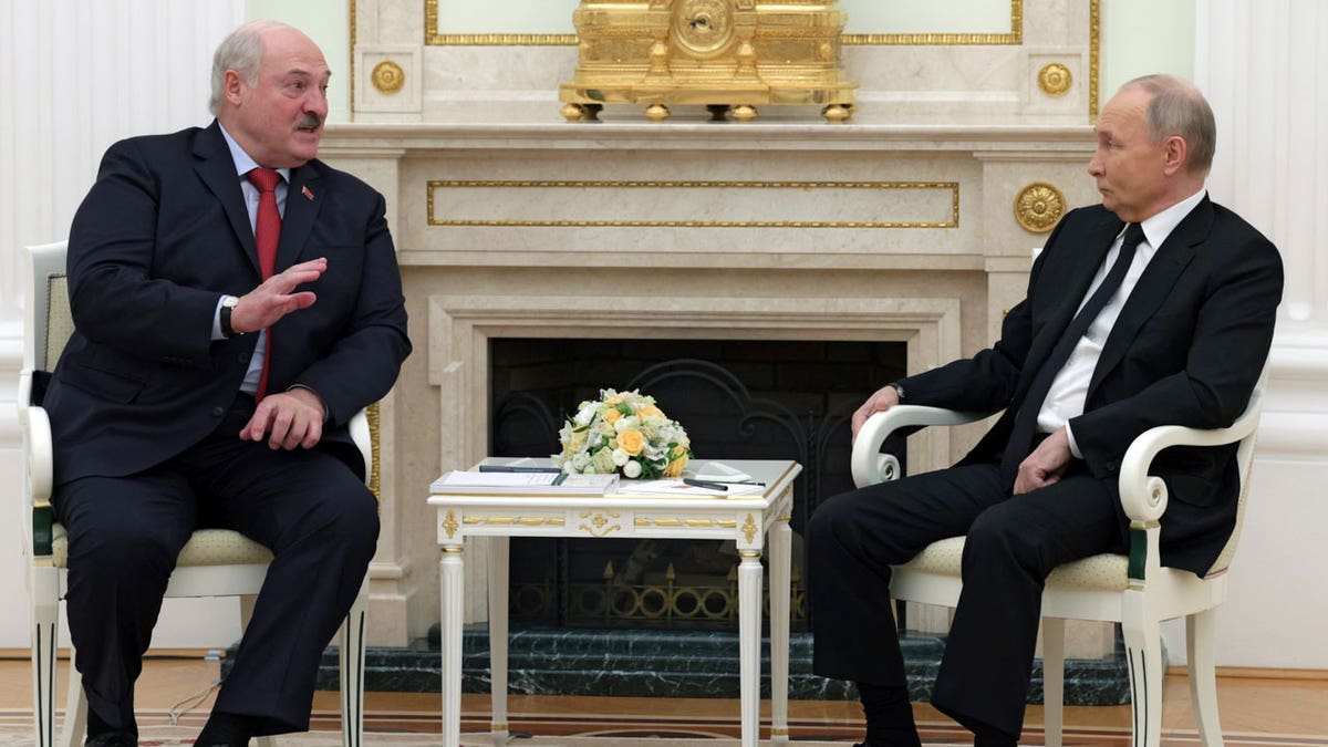 Russian President Vladimir Putin listens to Belarus President Alexander Lukashenko