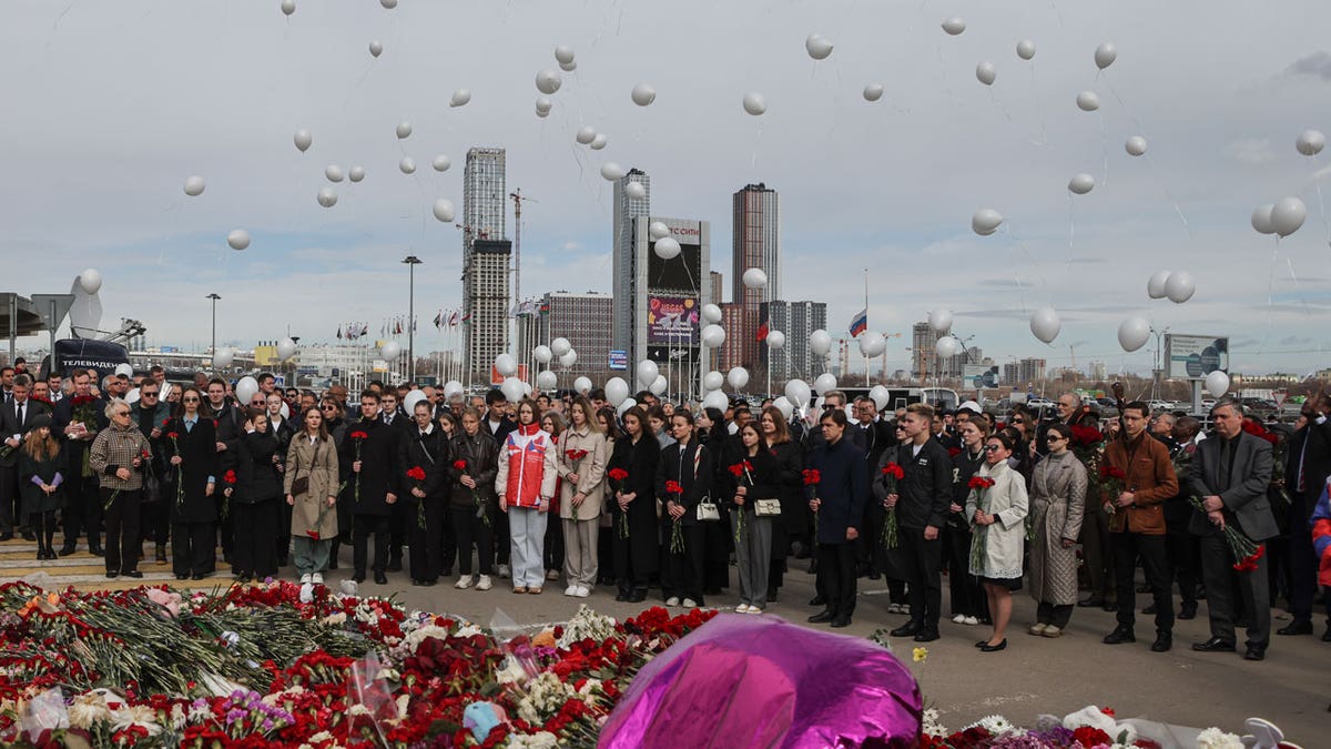 A ceremony at a makeshift memorial in front of the Crocus City Hall in Moscow