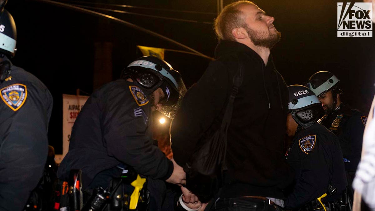 Officer arresting male protester