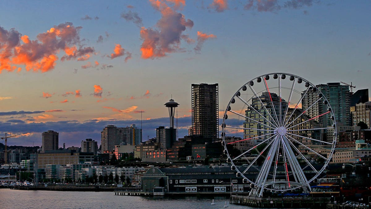 Seattle's waterfront and city skyline are seen, including the iconic Great Wheel and Space Needle