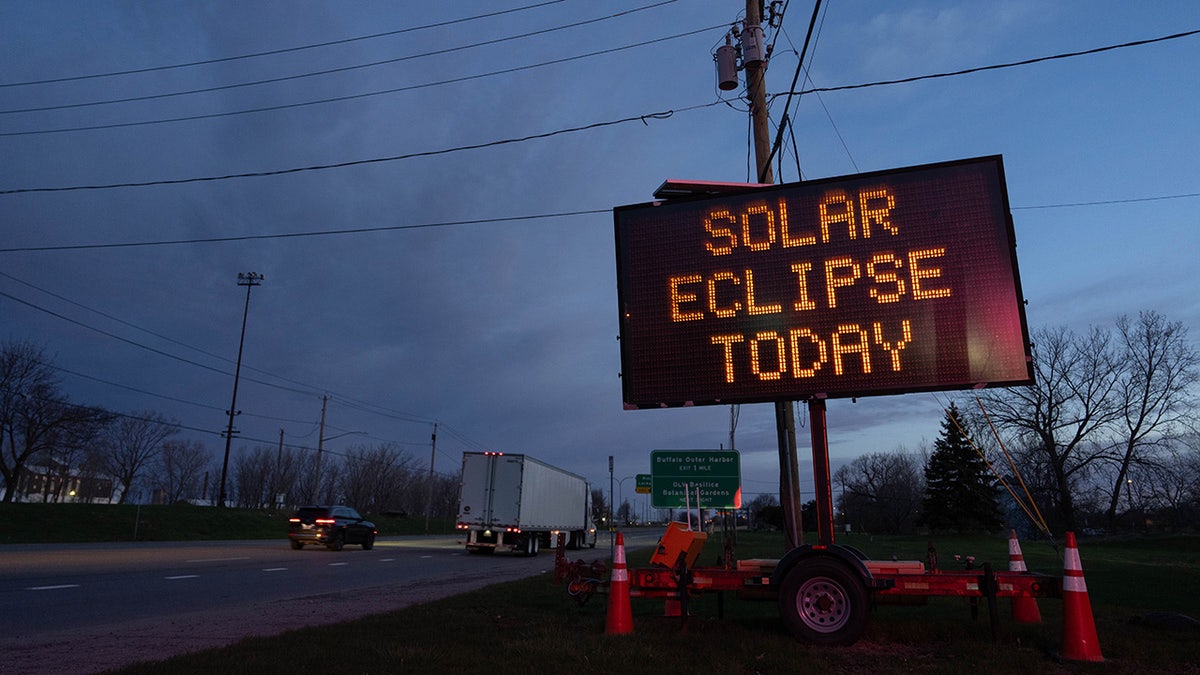 A matrix road sign displays a message for drivers about the solar eclipse
