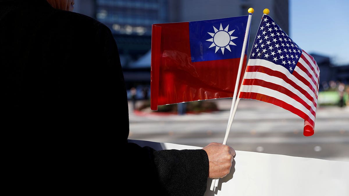 Demonstrator holds flags of Taiwan and the U.S.