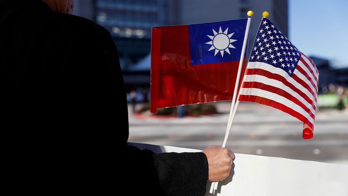 Demonstrator holds flags of Taiwan and the U.S.