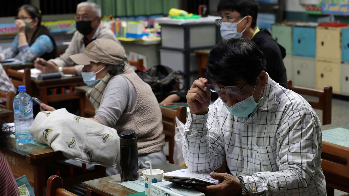 Students of Fake News Cleaner learn how to use the LINE app to identify fake news during a class in Kaohsiung City, southern Taiwan