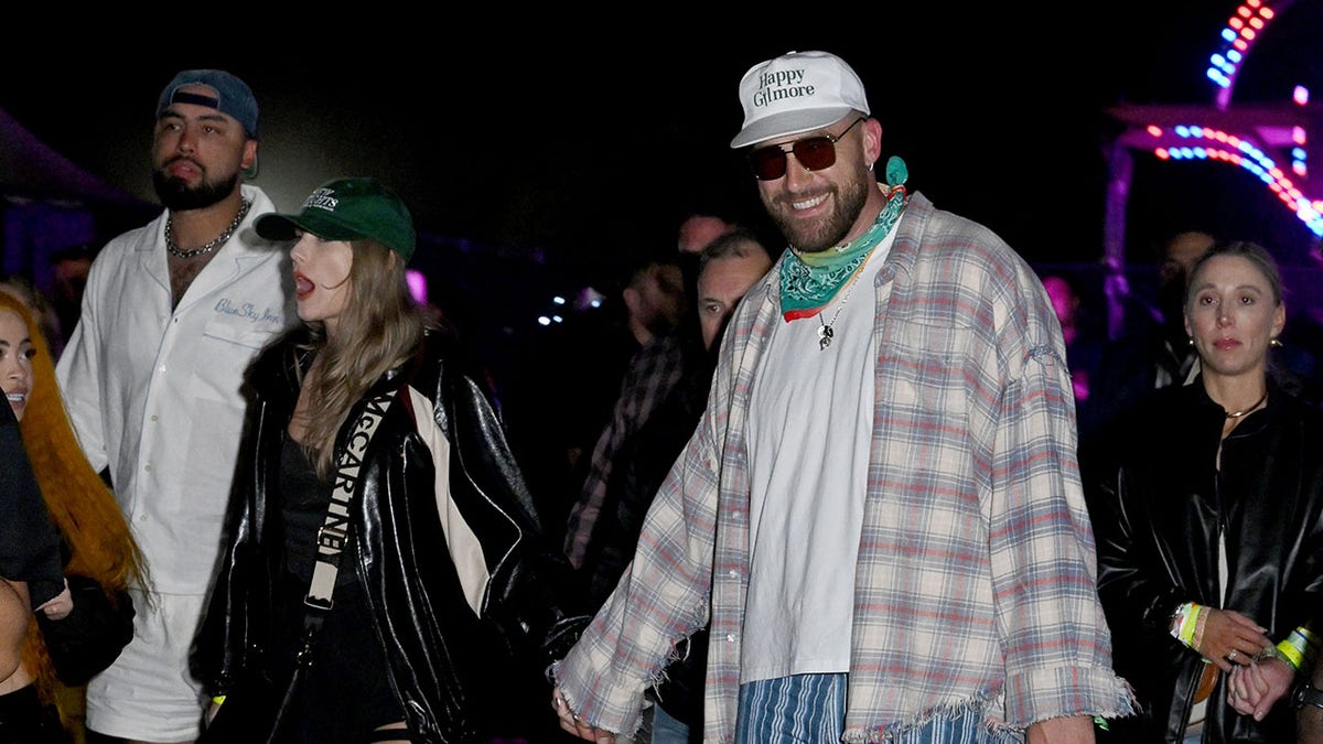 Taylor Swift holding Travis Kelce's hand as they walk at Coachella
