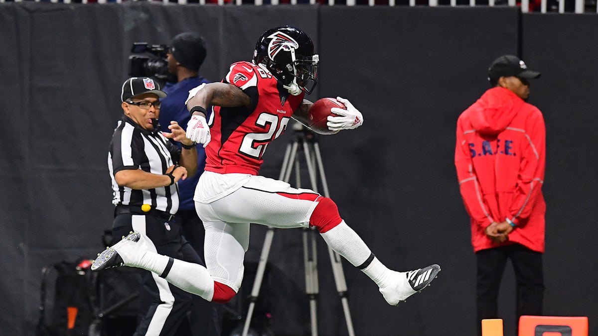 Tevin Coleman carries the football