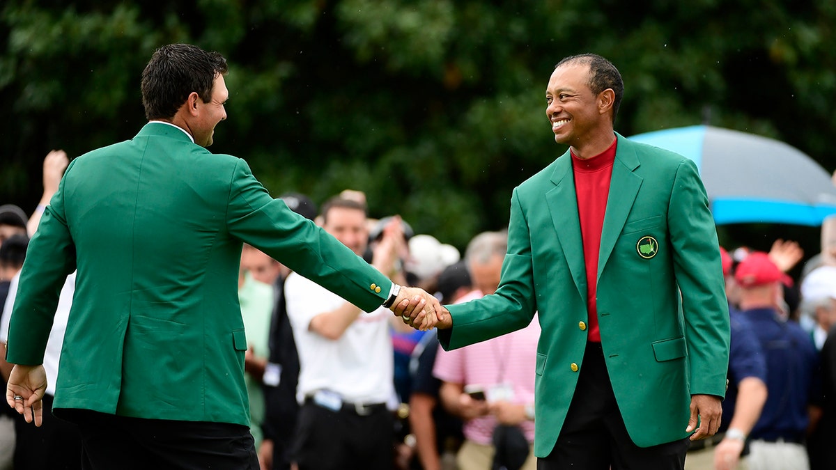 Tiger Woods shakes Patrick Reed's hand