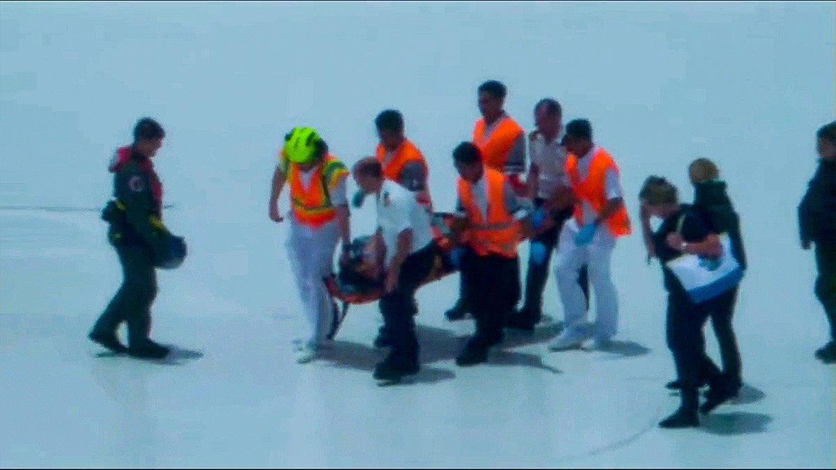 US coast guard team tends to pregnant woman on cruise deck