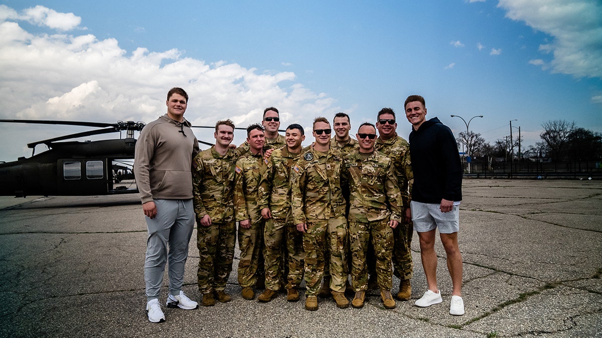 Joe Alt and Bo Nix with National Guard members