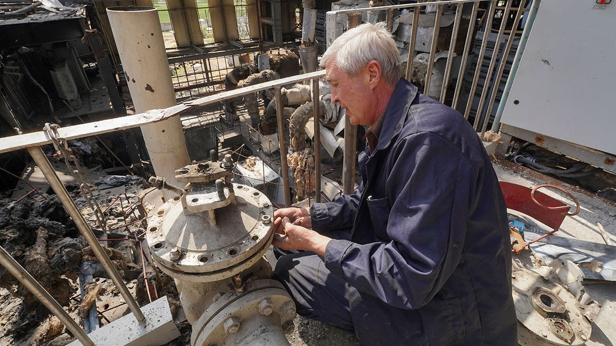 Worker repairs power plant