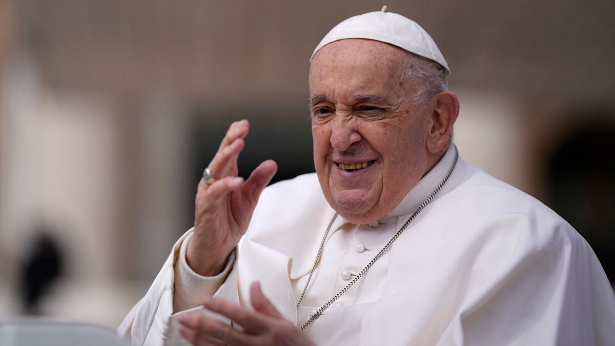 Pope Francis waves as he leaves after his weekly general audience in St. Peter's Square at The Vatican