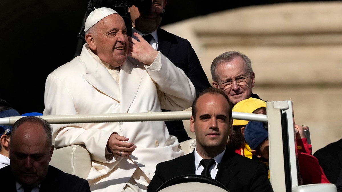Pope Francis rides in open-air vehicle