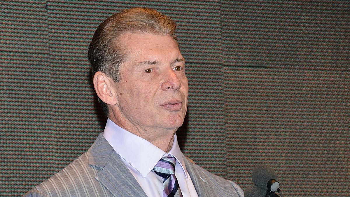 Vince McMahon looks at podium
