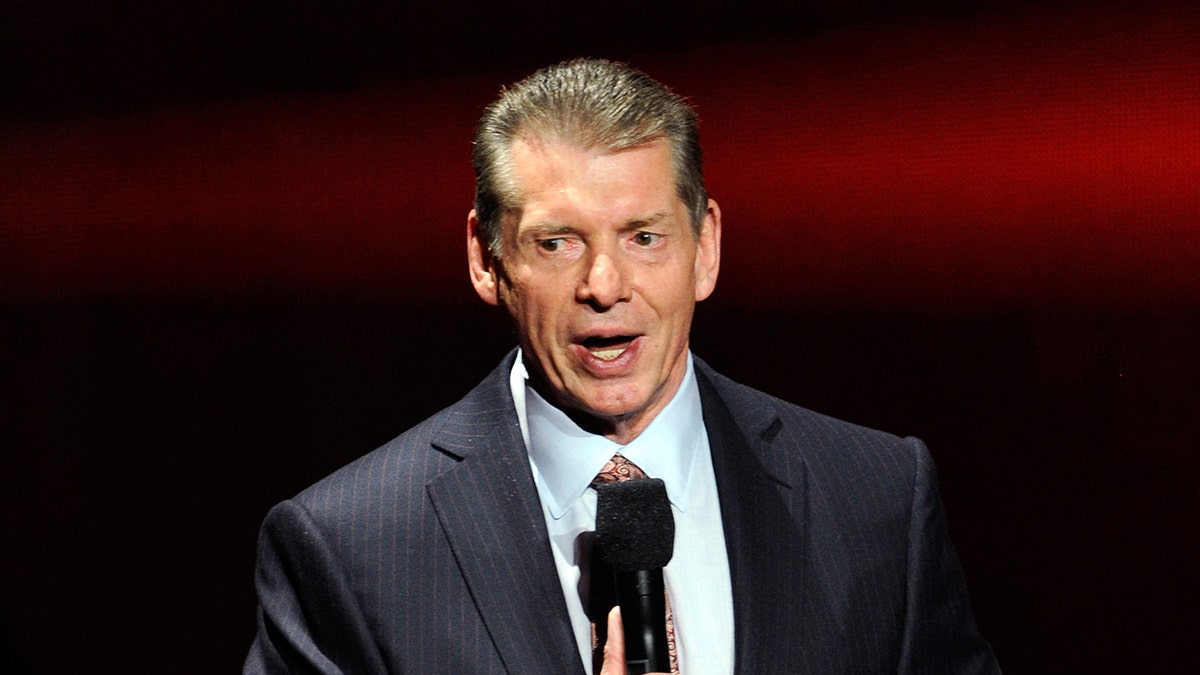 Vince McMahon talks into microphone