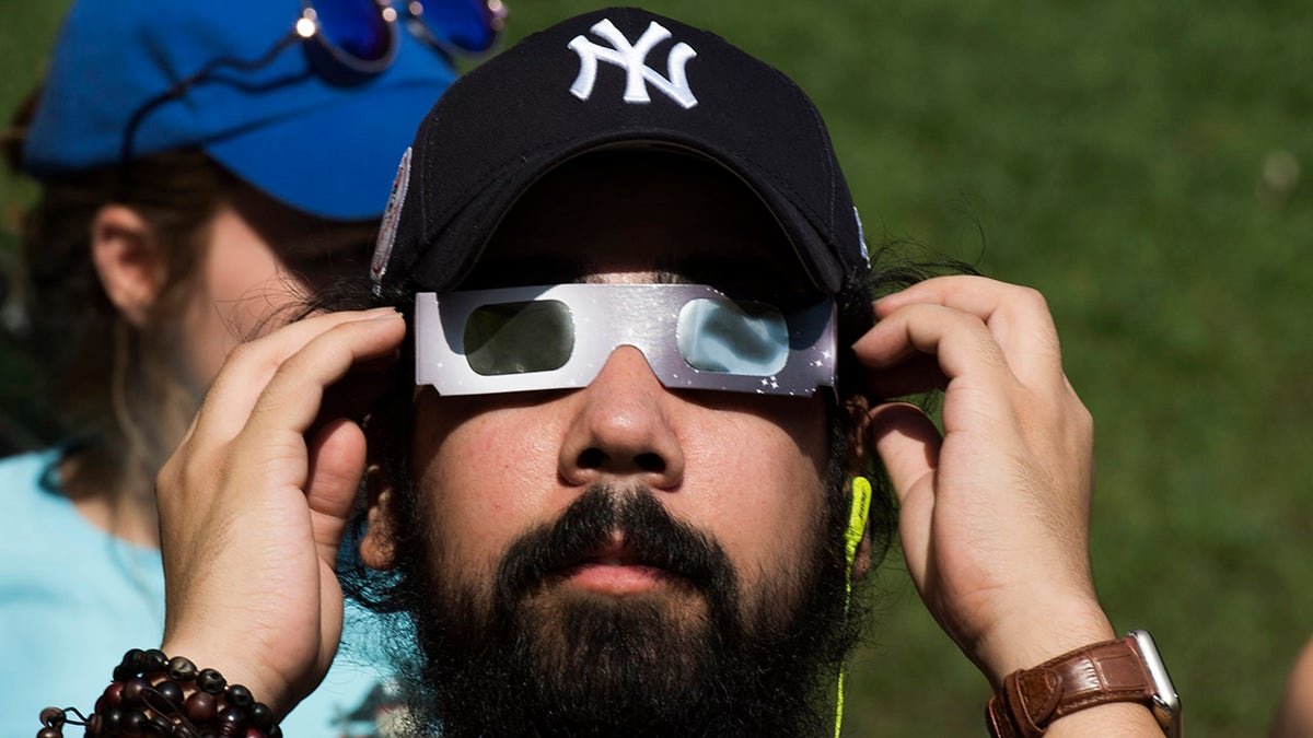Yankees fan watches an eclipse