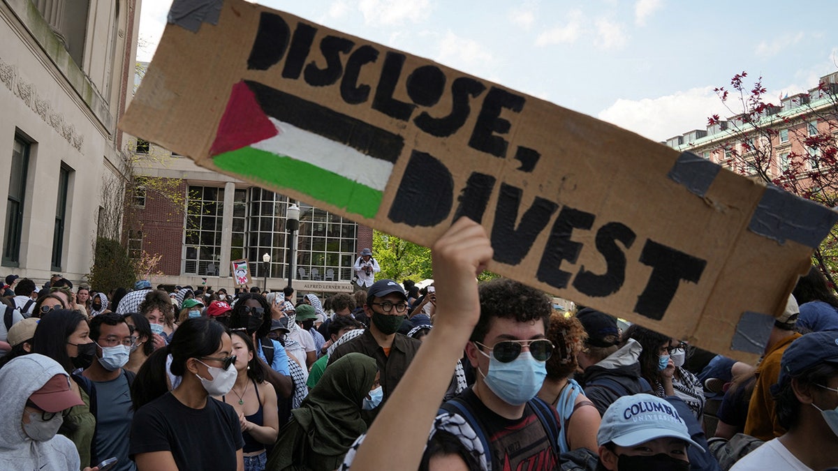 A protester holds a sign during a march on the Columbia University campus in support of a protest camp supporting the Palestinians.