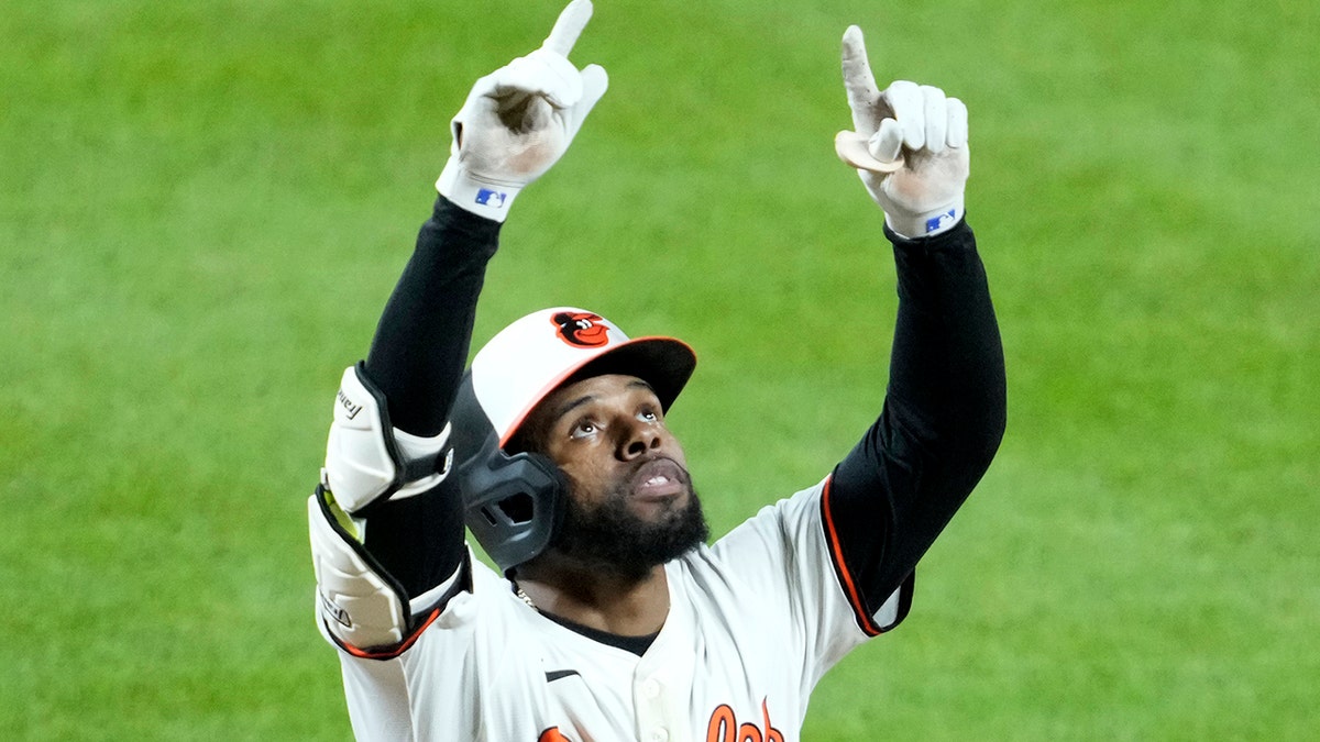 Cedric Mullins points up after home run